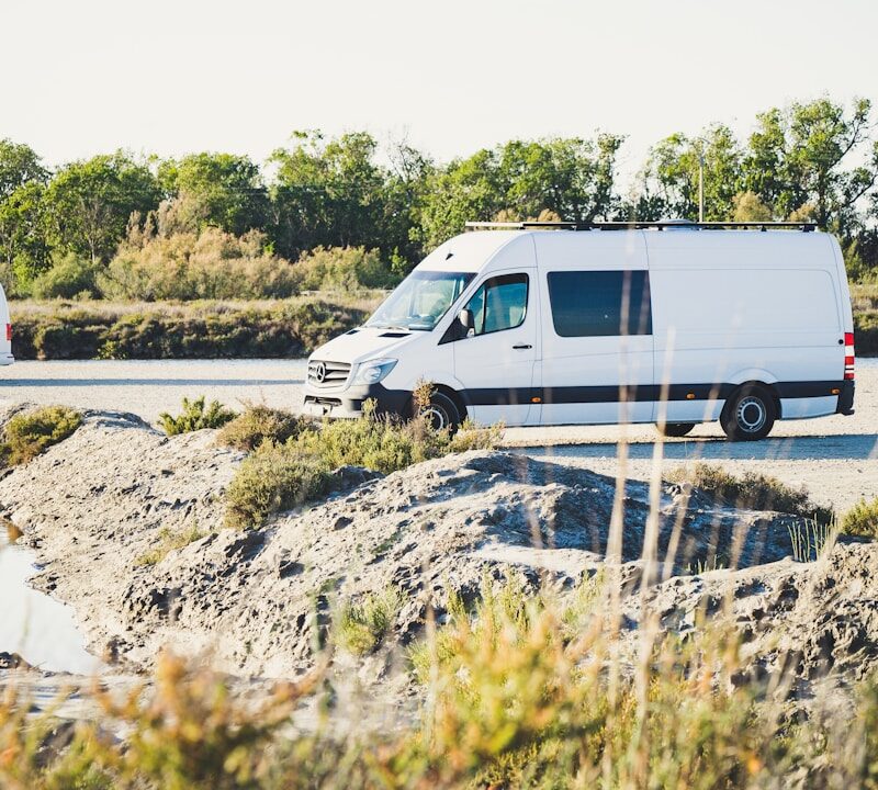 white van on gray concrete road during daytime